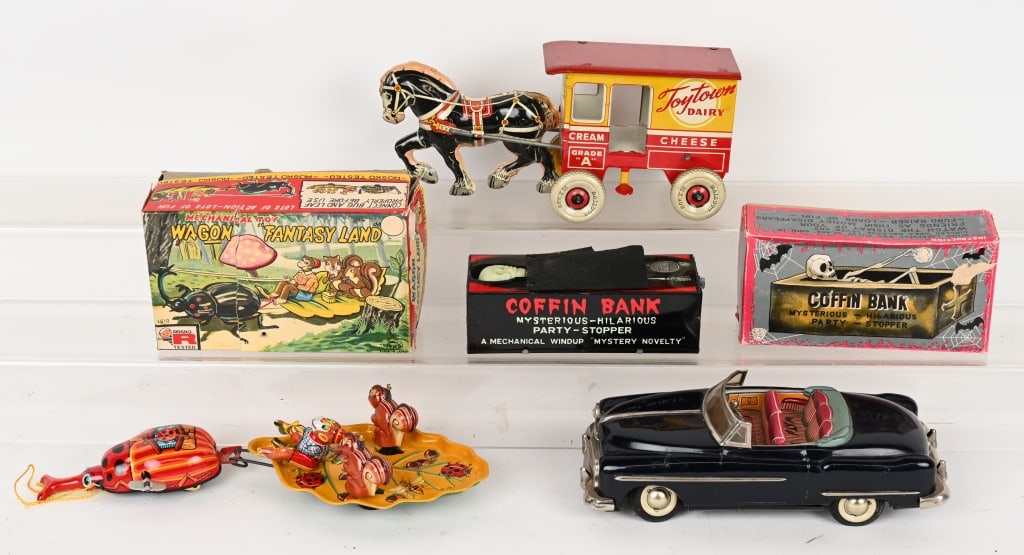LOT OF TIN TOYS: Includes TPS Wagon Fantasy Land, Marx Toytown Dairy Wagon, Coffin bank, and Japan Battery Operated Car. Excellent