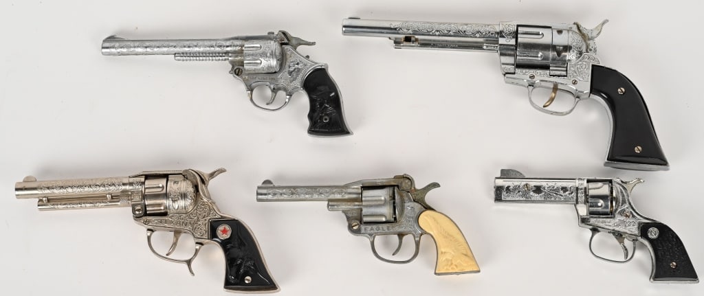 5- COWBOY REVOLVER CAP GUNS: Includes Kit Carson, Hubley, Eagle, Texan, and Stallion. All in nice original condition. Largest 13" AS-IS