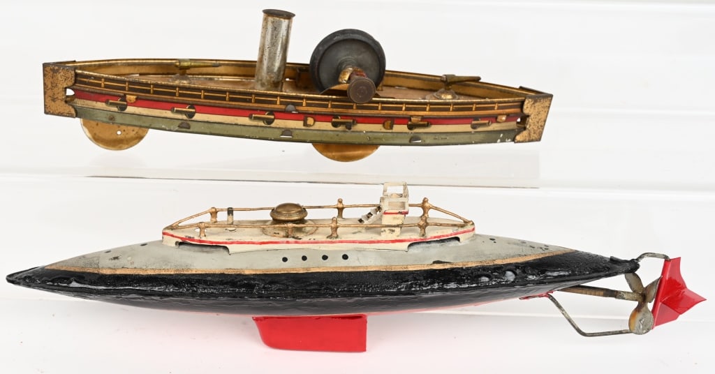 BING CLOCKWORK SUBMARINE & HESS GUN BOAT: Lot includes: 1. 12" Tin Bing Submarine, black and red is repainted, the rest is original. Spring has tension, but not working. 2. 9" Tin Hess Flywheel drive gun boat. Complete and original, working.,