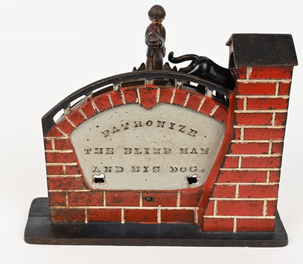 J&E STEVENS PATRONIZE THE BLIND MAN MECH BANK: Patronize the Blind Man cast iron mechanical bank. To operate the bank, you must put a penny in the spring-loaded hands of the blind man. Carefully pulling the lever leftwards causes the dog to walk t