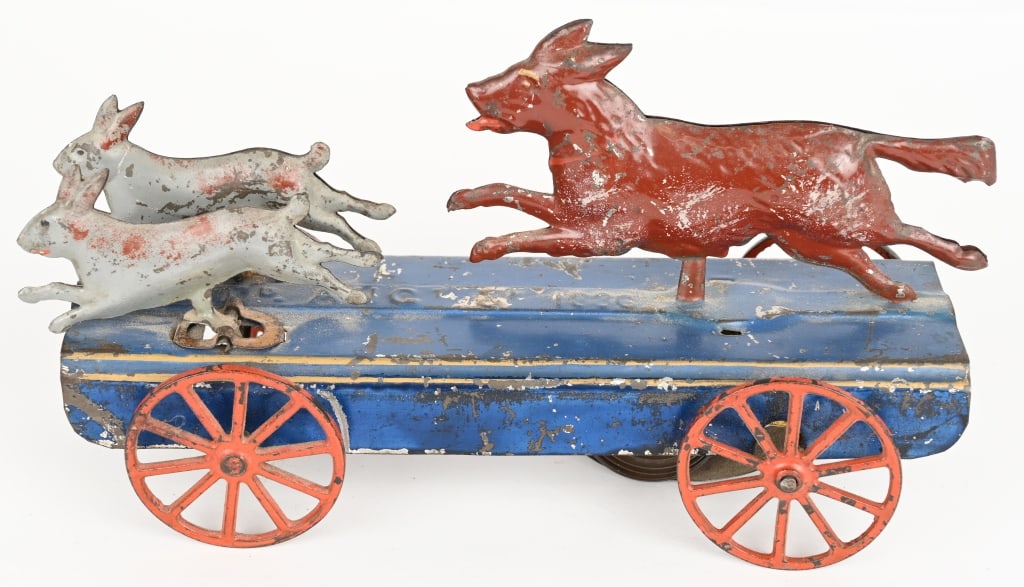 FALLOWS TIN CLOCKWORK DOG & RABBITS TOY: Rare Fallows clockwork toy of a dog chasing two rabbits. All the figures have been professionally reattached. Nice original paint. Motor worked when tested, and includes original key. 9" Excellent