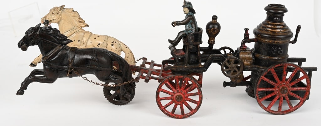 CARPENTER CAST IRON No. 53 FIRE PUMPER: Great early Carpenter No. 53 Fire Pumper. The toy looks to be all original with the exception of the white horse that has touch up. No cracks or repairs. 19". Very Good-Excellent
