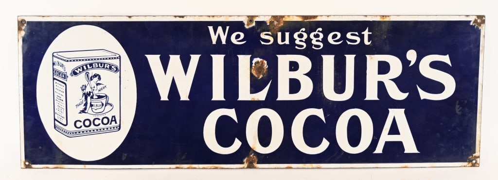 WILBUR'S COCOA PORCELAIN SIGN: Nice original Wilbur's Cocoa porcelain sign. Has nice colors. Few spots of loss mostly near mounting holes. 30"x10" Very Good-Excellent