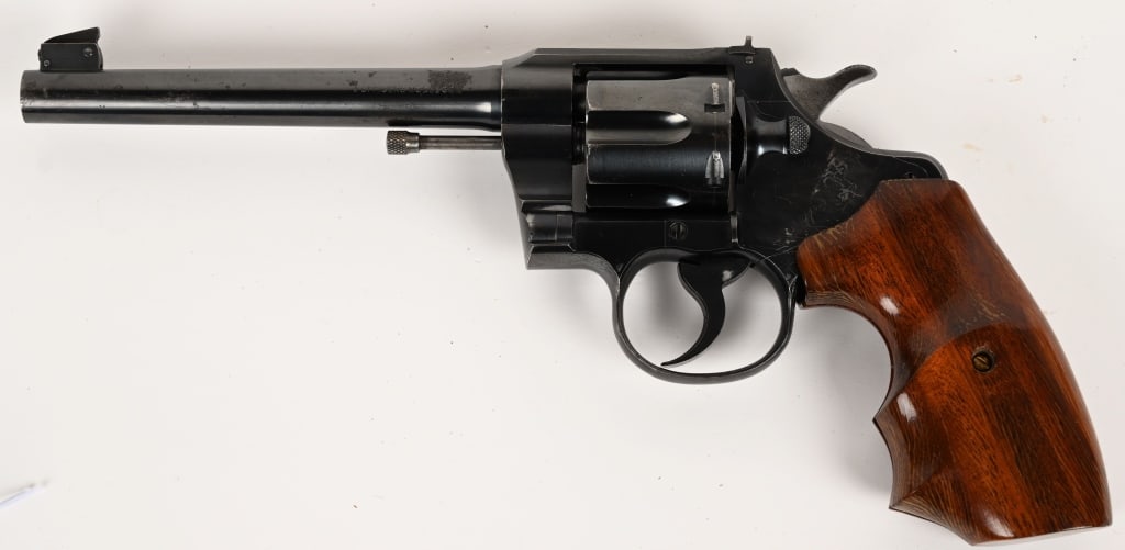 COLT OFFICERS MODEL DA REVOLVER .38 SPECIAL: SERIAL NUMBER: 596583. BARREL: 6". CALIBER: .38 SPL. MANUFACTURED: 1950. This revolver features a heavy, target-style barrel, adjustable sights, and a high-quality, knurled trigger face and a smooth t