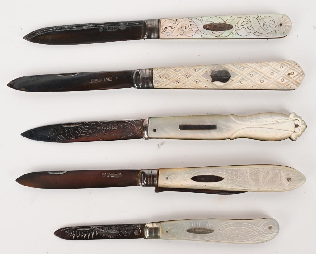 FIVE ASSORTED PEARL & SILVER BLADE FRUIT KNIVES: This assortment contains 5 folding fruit knives that feature mother-of pearl handles and sterling silver blades from various manufacturers with proof marks. The knife itself is also known as a "slippi