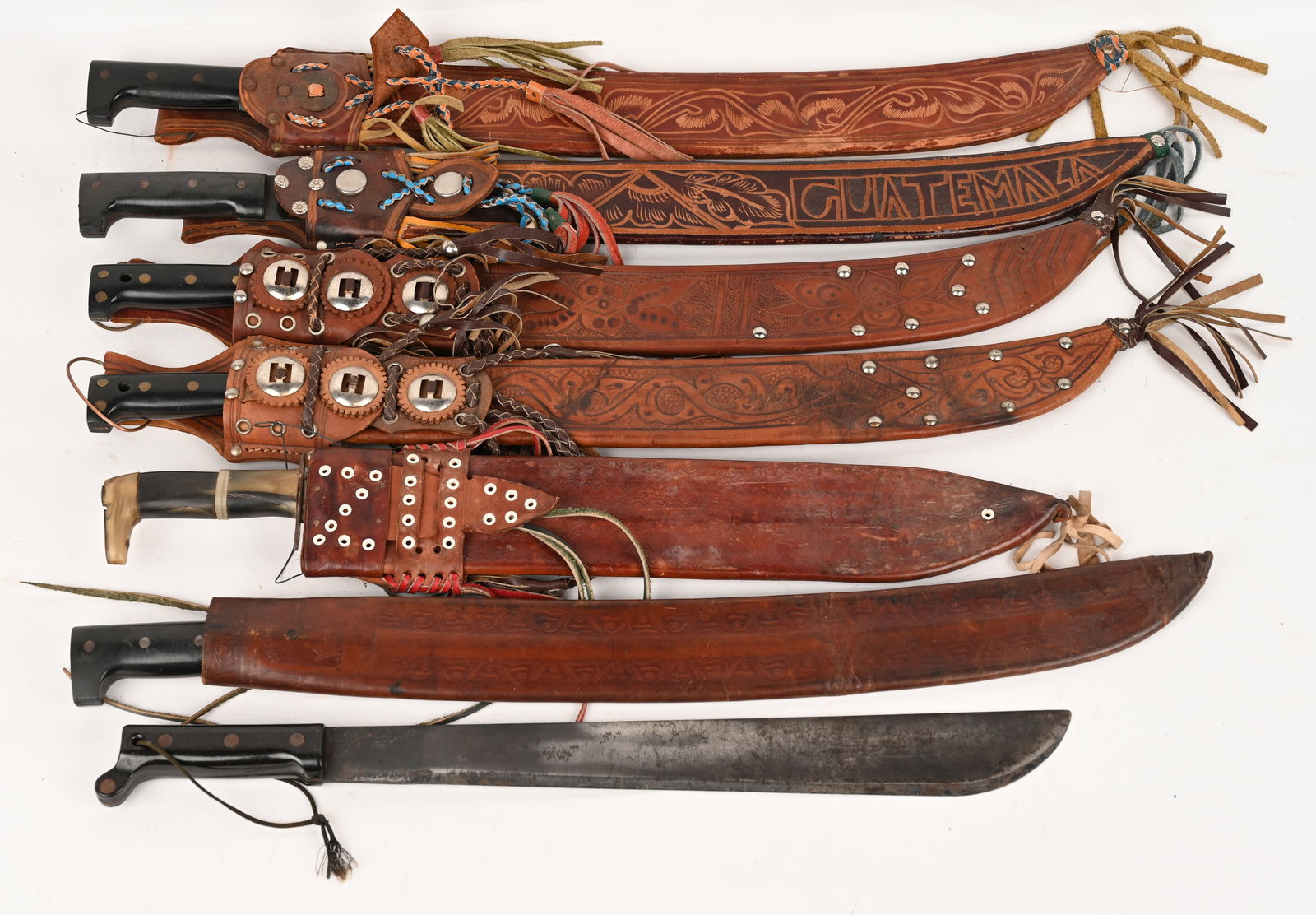 LOT OF SOUTH AMERICAN RATHER LARGE MACHETES: This lot contains 7 machetes from South America. Blades are as long as 24". CONDITION: Very Good. Feature handling / storage wear.