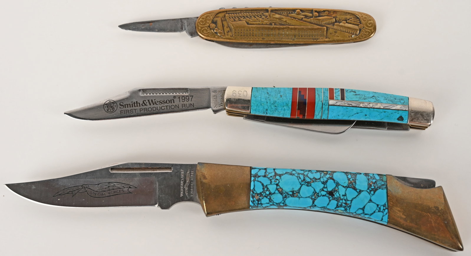 THREE UNIQUELY DESIGNED & APPOINTED POCKET KNIVES: THE CONDOR KJ47 3 BLADE POCKET KNIFE. Blade:2 1/8". OAL:6 3/16". This is a rare Condor pocket knife made in Holland. It features a splendid factory scene on the brass handle. It features a cork screw 