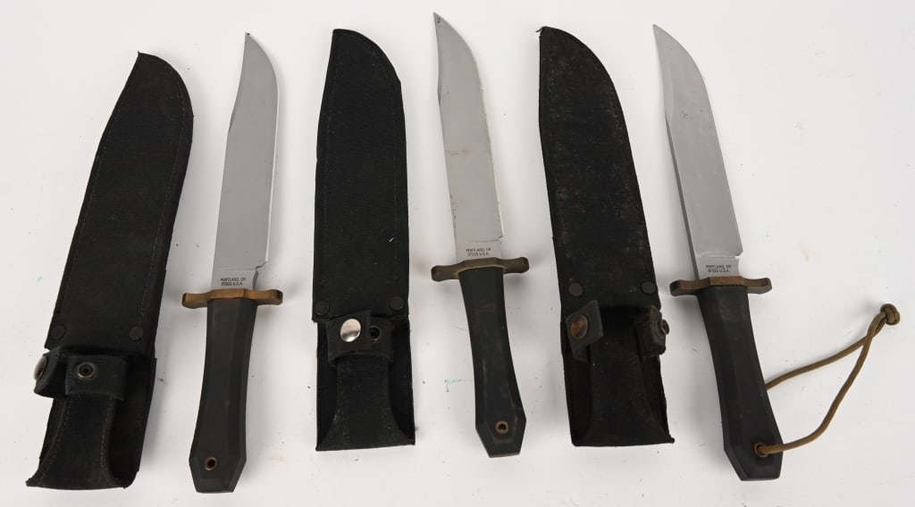 LOT OF GERBER SURVIVAL KNIVES: This lot contains: (3) Gerber 5978 Coffin Handle Bowie knives with black nylon sheaths and rubber grips. Blade: 9 1/2". OAL 14 1/4". Condition. Very Good. All brass guards have a patina. All blades ar