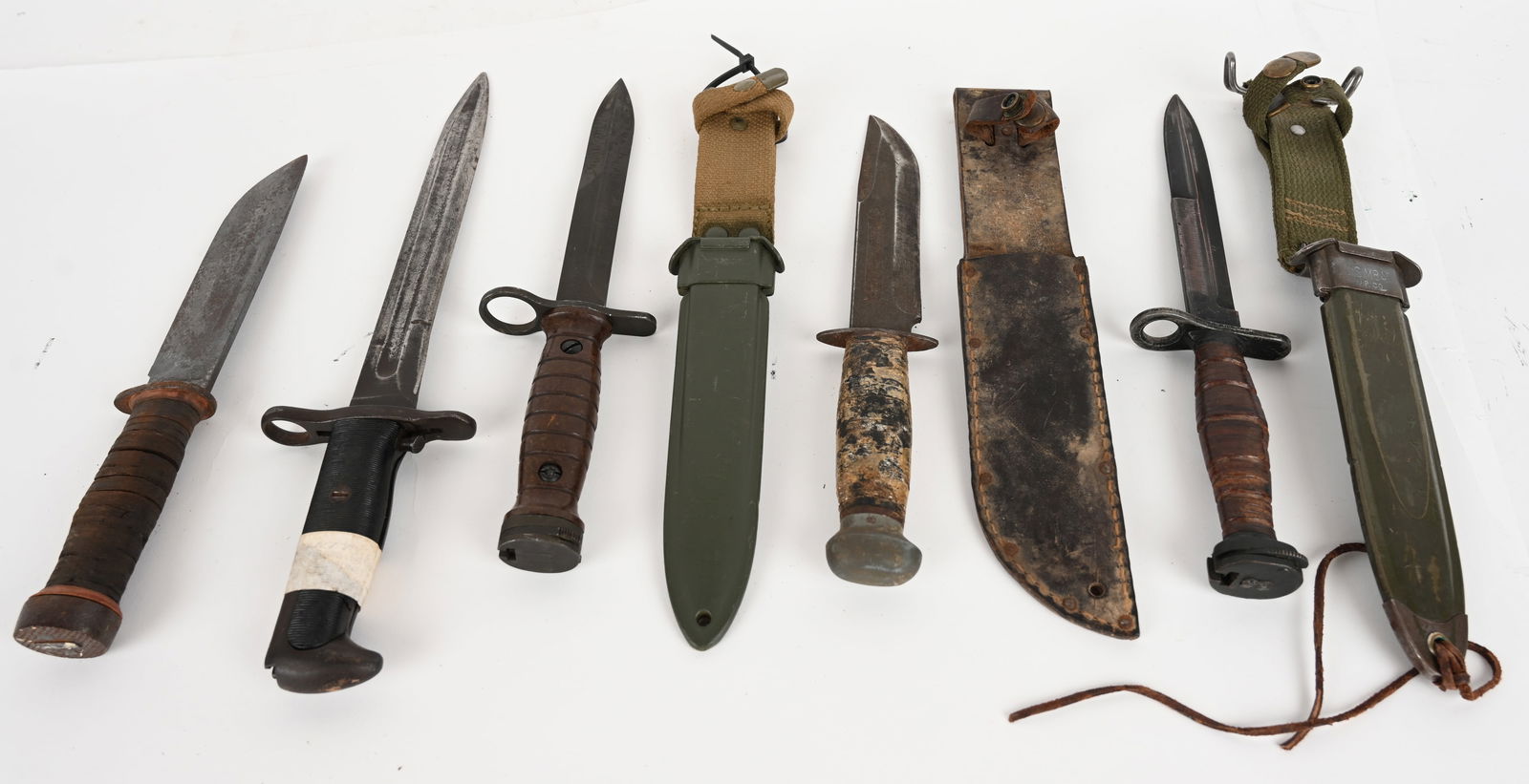 VINTAGE BAYONET AND FIGHTING KNIVES: This is a lot of 5 knives. (1) VP CO. US M8 A1 bayonet with sheath. Blade: 6 3/4". OAL: 11 5/8". Condition: Good (1)Cattargaugus model 225Q knife. Blade: 6". OAL: 10 1/2". Condition: Fair. The blade i