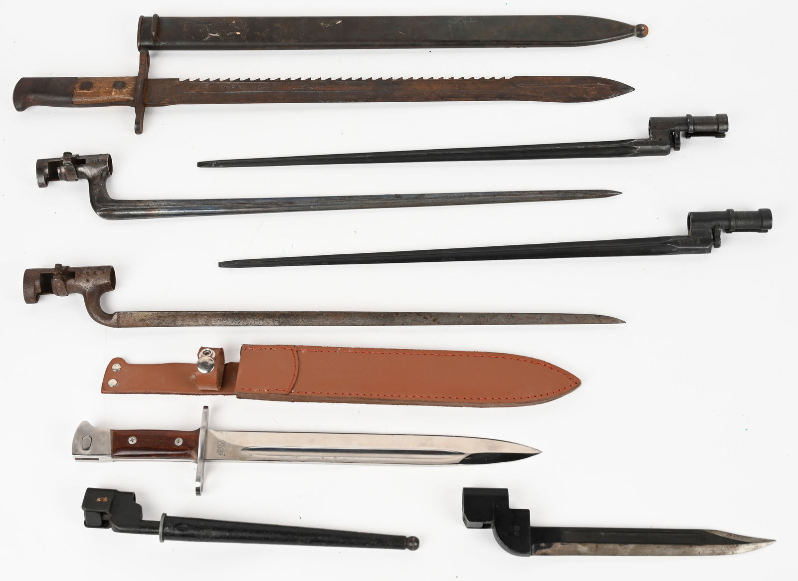 LOT OF BAY-O-NETS, ENFIELD, SWISS, M1863 & MORE: This lot contains Good to Very Good condition bayonets unless otherwise noted. (1) British No 4 MK2 spike bayonet and scabbard. (2) British MK4 sword bayonets. One in grease (1) British MK4 scabbard i