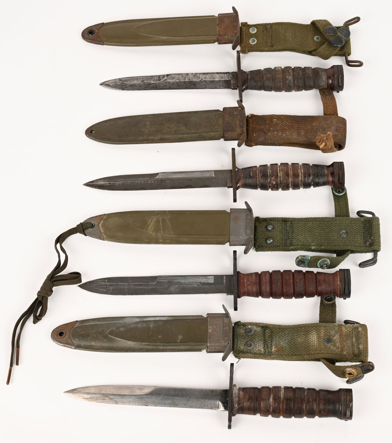 LOT OF FOUR POST WAR BAYONETS: This lot contains 4 M1 carbine bayonets from manufacturers such as Imperial and Camillus. CONDITION: Very Good.