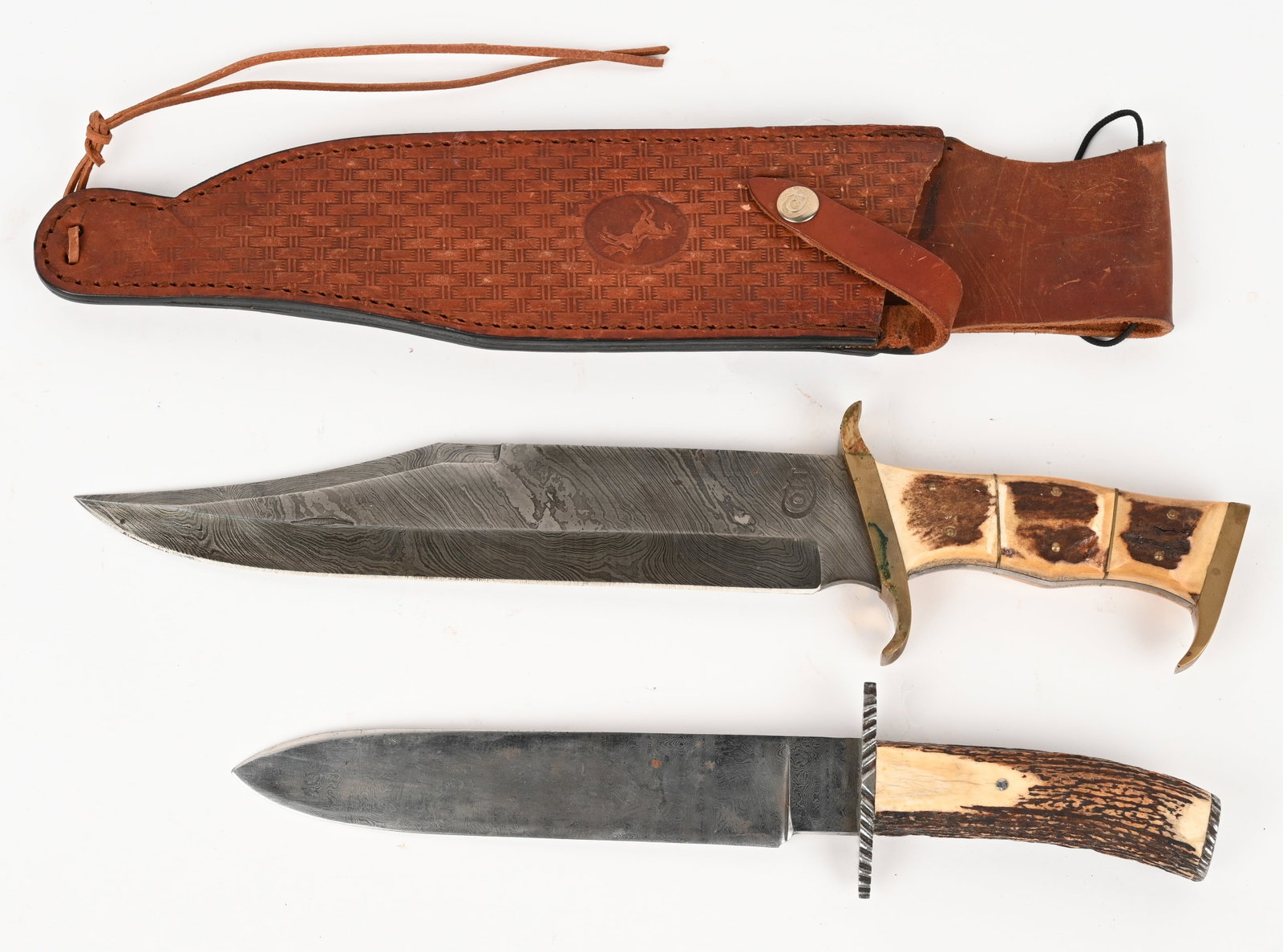 LOT OF (2) DAMASCUS KNIVES: This lot contains (2) Damascus blades. (1) H.J. Miller fixed damascus blade, guard and cap with stag handle. Blade: 8 3/8". OAL:13 1/4". Condition: Very Good. Small frosting spot on blade. (1) Colt da
