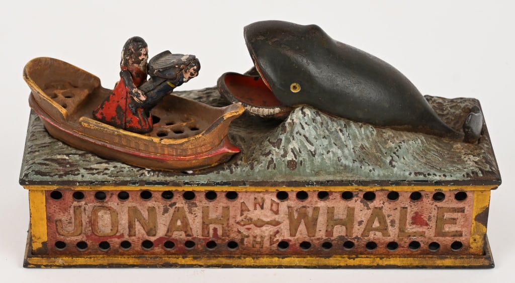 SHEPARD JONAH AND THE WHALE MECHANICAL BANK: Jonah and the Whale cast iron mechanical bank. Works properly. The boat is a replacement, although the figures appears to be original. The bank has fading to the original paint. The trap is original. 