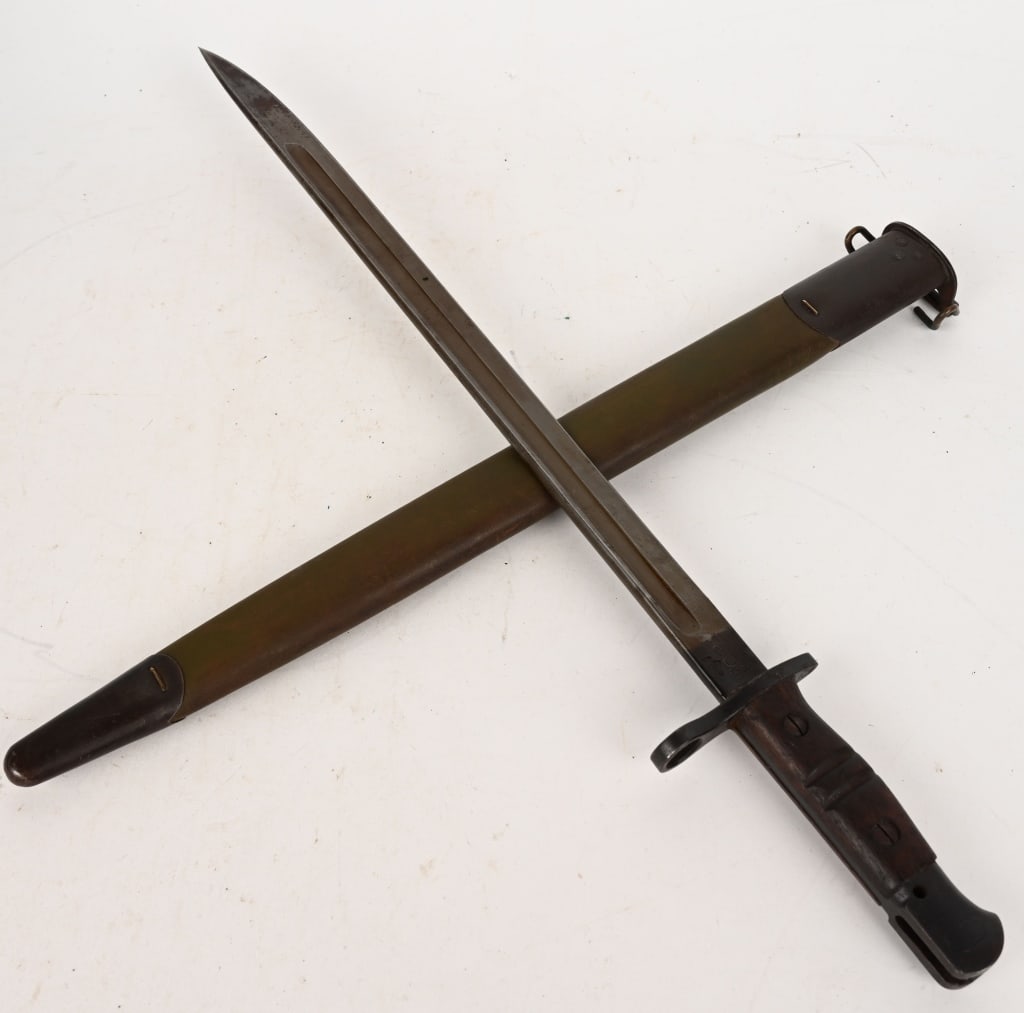 WW1 M1917 BAYONET BY REMINGTON w/ SCABBARD WWI: WWI era US Model 1917 bayonet, made by Remington, with bursting bomb proof, ordnance stamps, Eagle's head and "26" mark on the blade. Dated 1917, and includes first pattern green leather scabbard. Bla