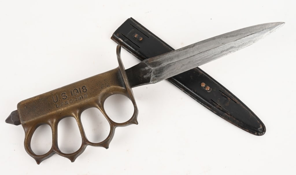 WWI US M1918 TRENCH KNIFE LF&C W/ SCABBARD WW1: Model 1918 "Knuckle Duster" Trench knife with solid brass handle made by Landers, Frary, and Clark and so marked "L. F. & C." on the handle and on the scabbard. Features spiked knuckle guards, and "Sk