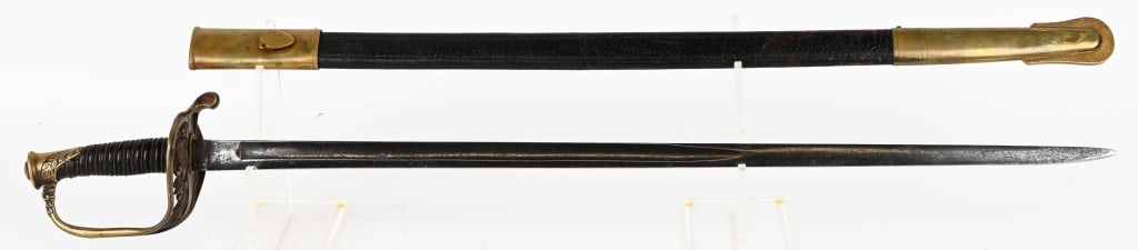MARINE CORPS NCO SWORD & SCABBARD BY WKC USMC: US Marine Corps NCO ceremonial sword by WKC Swords, Solingen, Germany. Includes leather and gold-colored scabbard 32 inches long overall. Etched blade that shows graying and some light pitting.