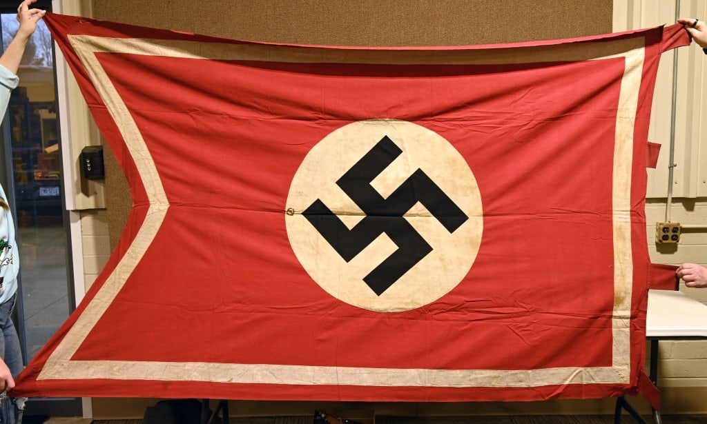 WWII NAZI GERMAN SWALLOWTAIL BANNER OR FLAG WW2: Roughly 55 x 94 inches, double sided cotton Swallowtail construction pennant. The pennant features a red base field with a separate central white circular disk with a printed canted black swastika to