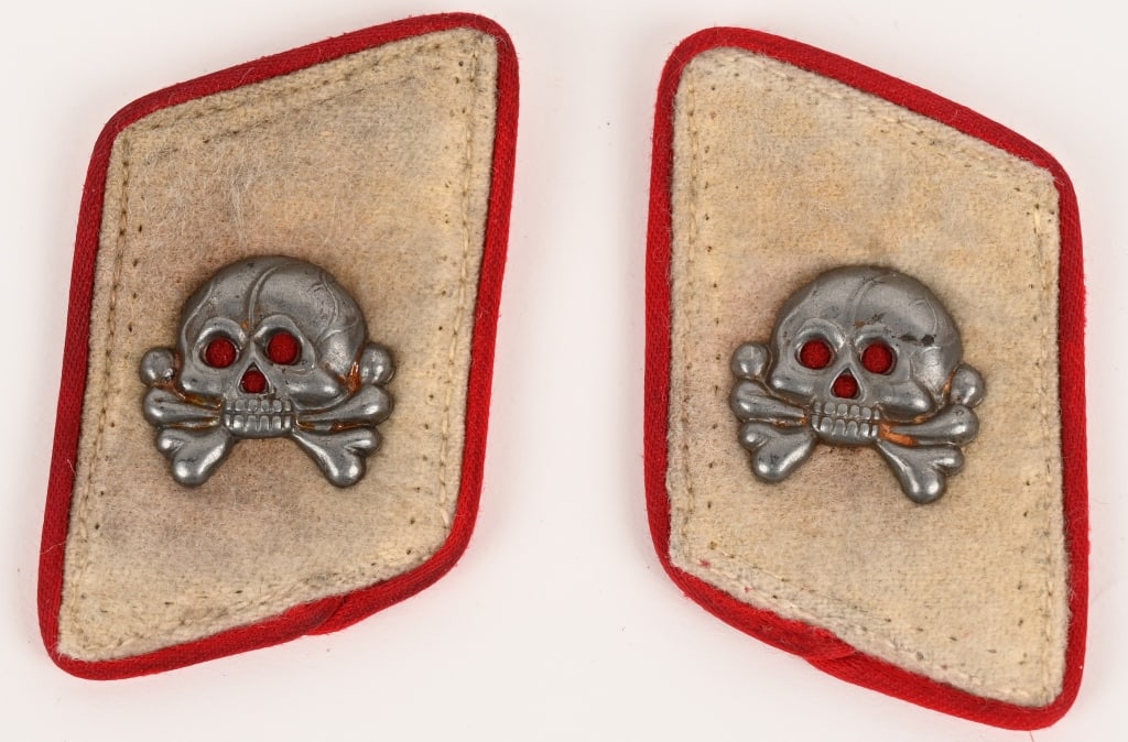 WWII NAZI GERMAN HERMANN GÖRING FLAK COLLAR TABS: White wool tabs with red rayon piping. Skulls to the front. Nice salty worn and used examples. The Reichsluftwaffe was officially established on February 26TH 1935 as the third branch of service of th