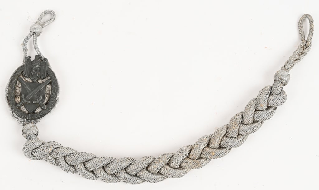 WWII NAZI WEHRMACHT GRADE ONE MARKSMAN'S LANYARD: WEHRMACHT GRADE ONE MARKSMAN'S LANYARD. Second pattern grade one marksman's lanyard consists of a heavy, twisted, interwoven silver/aluminum braid with buttoning loops to both the top and bottom ends.