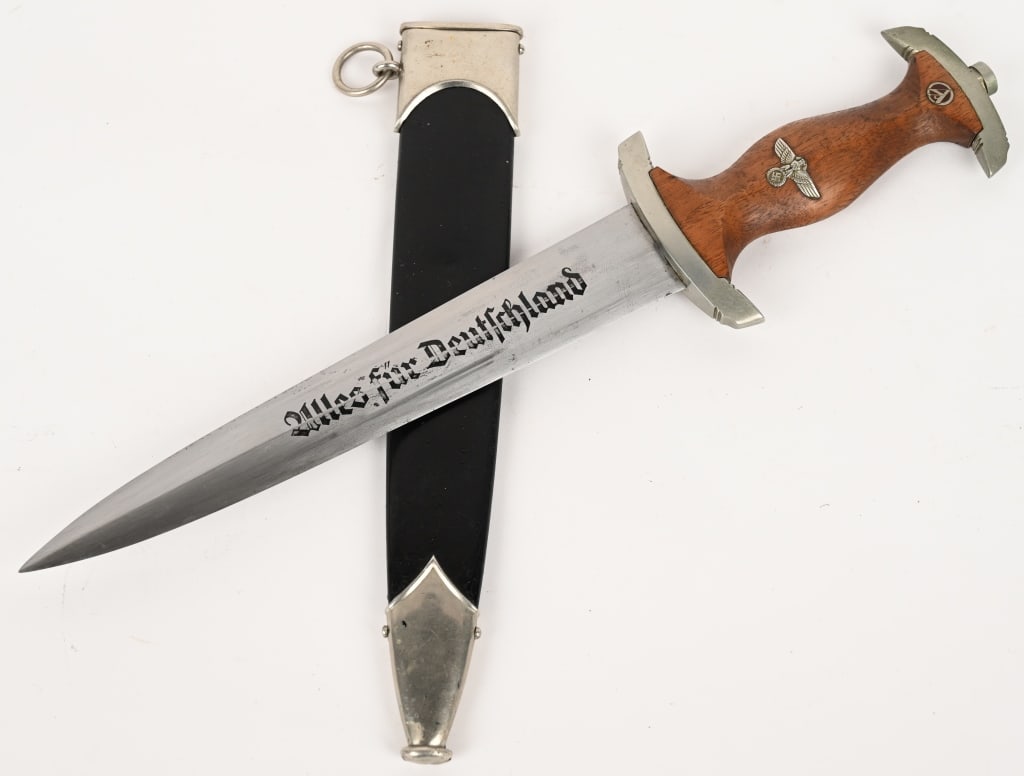 WWII NAZI GERMAN NSKK DAGGER BY J.P. SAUER & SOHN: Double edged, nickel/silver plated blade with a low central ridge. Blade is in overall excellent condition with original cross-graining still visible. Shows the normal scabbard runner marks and typica