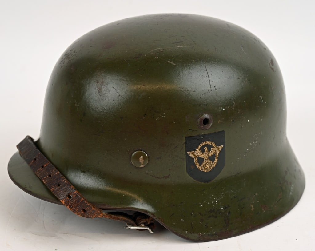 WWII NAZI GERMAN M35 DOUBLE DECAL POLIZEI HELMET: Helmet retains most of it’s original smooth field-gray paint. Second pattern, un-bordered Police eagle decal and pointed tip, party shield decal are both retained about 98%. All three liner reta