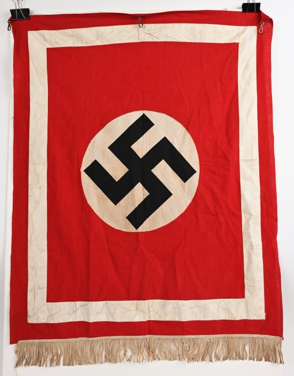 WWII NAZI GERMAN NSDAP POLITICAL PODIUM BANNER WW2: Approximately 36 inches tall X 38 wide single sided multi-piece woven rayon construction banner features a red base field with a separate, machine stitched white circular field to the center with a bl