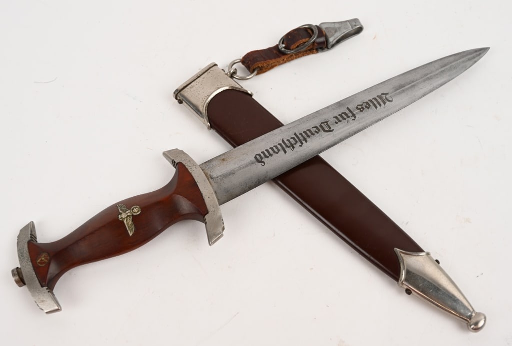 WWII NAZI GERMAN SA M33 DAGGER BY M/7/66 WW2: Roughly, 22cm long, double edged, nickel/silver plated, drop forged steel construction blade with a low central ridge. The blade shows the expected scabbard runner marks with some of the original cros