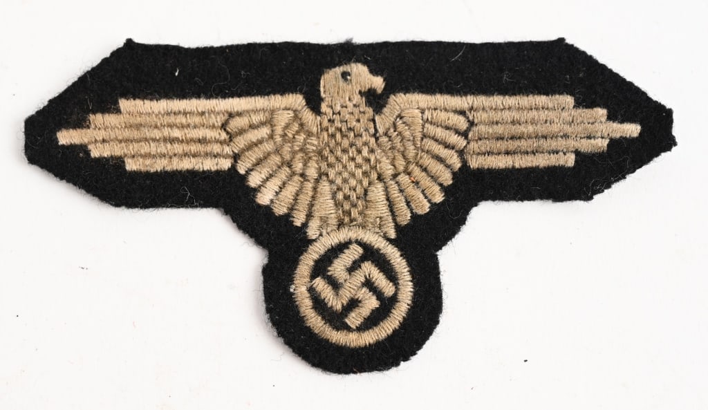 WWII NAZI GERMAN SS EM/NCO'S SLEEVE EAGLE WW2: Second pattern (Circa 1939-1945), machine embroidered SS sleeve eagle with out-stretched wings in silvery/grey, rayon threads on a black wool base. This is the final pattern machine embroidered versio