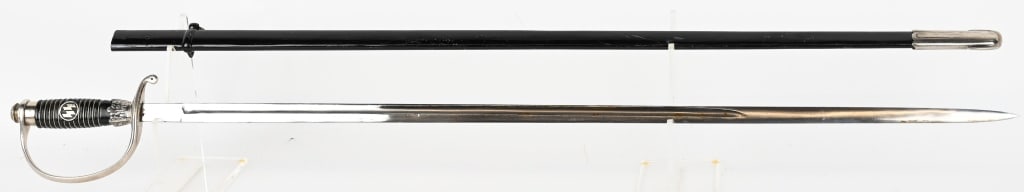 WWII NAZI GERMAN SS SCHUTZSTAFFEL OFFICERS SWORD: The hilt of this example is nickel-plated. The upper area has the built-in step area that accommodates the tang/pommel cap. The pommel is a fine example having crisp serration and does not appear to h