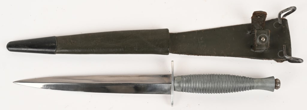 FAIRBAIRN SYKES FIGHTING KNIFE ENGRAVED: Unusual Fairbairn Sykes Knuckle Fighting Knife measuring 11 1/2 inches overall with a stiletto blade that measures 6 3/4 inches. Blade is etched "Dieu et mon droit" or God and my right with the Englis