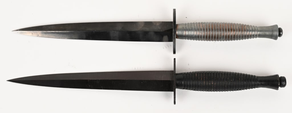 WWII BRITISH FAIRBAIRN SYKES FIGHTING KNIFE LOT: Lot of 2, British Fairbairn Sykes Fighting Knives measuring 11 1/2 inches overall with a stiletto blade that measures 6 3/4 inches. Zinc cast grips are excellent. The knife showing wear to the grip ha