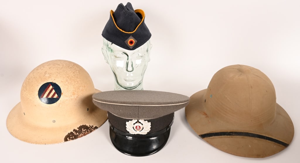 MILITARY LOT OF HEADGEAR US GERMAN WWII & POST: Lot of Military Headgear to include 1) CIVIL DEFENCE HELMET. Complete with liner and is in excellent condition. 2) EAST GERMAN NCO VISOR HAT. Size 57 and is in excellent 3) WWII US PITH HELMET .