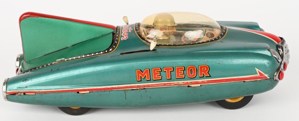 JAPAN BATTERY OP METEOR SPACE CAR: Japan battery operated Meteor Space Car. Great looking Car with Driver under plastic dome. Rear tail has been replaced and has some normal wear. Not working. Displays great. 12" Very Good-Excellent