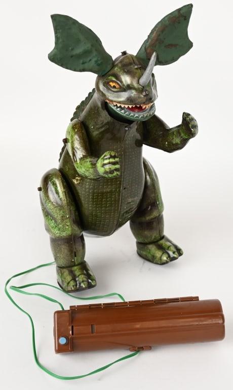 TOHO BULLMARX BATTERY OP BARAGON: Japan battery operated Baragon. All original tin and vinyl figure with Remote Control battery box. Toy is in great condition with wonderful details. Walks and screams great when tested. 14 1/2"