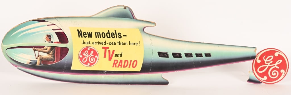 GE TV & RADIO ROCKETSHIP ADVERTISEMENT: 1950s General Electric New Model TV and Radio Rocketship Advertisement. Double sided made of heavy cardboard. Has great colors and graphics. Tail section is loose but present. very cool piece. 43"