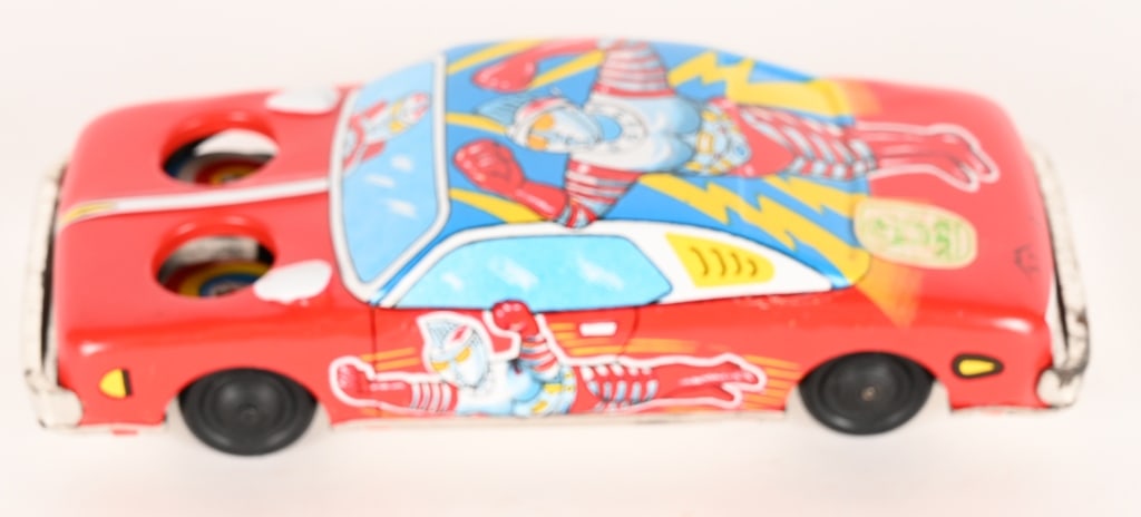 ST TIN FRICTION ULTRAMAN ACE CAR: Japan tin friction Ultraman Ace Car. Red in color. All original with great colors and graphics. Friction works. 6" Excellent