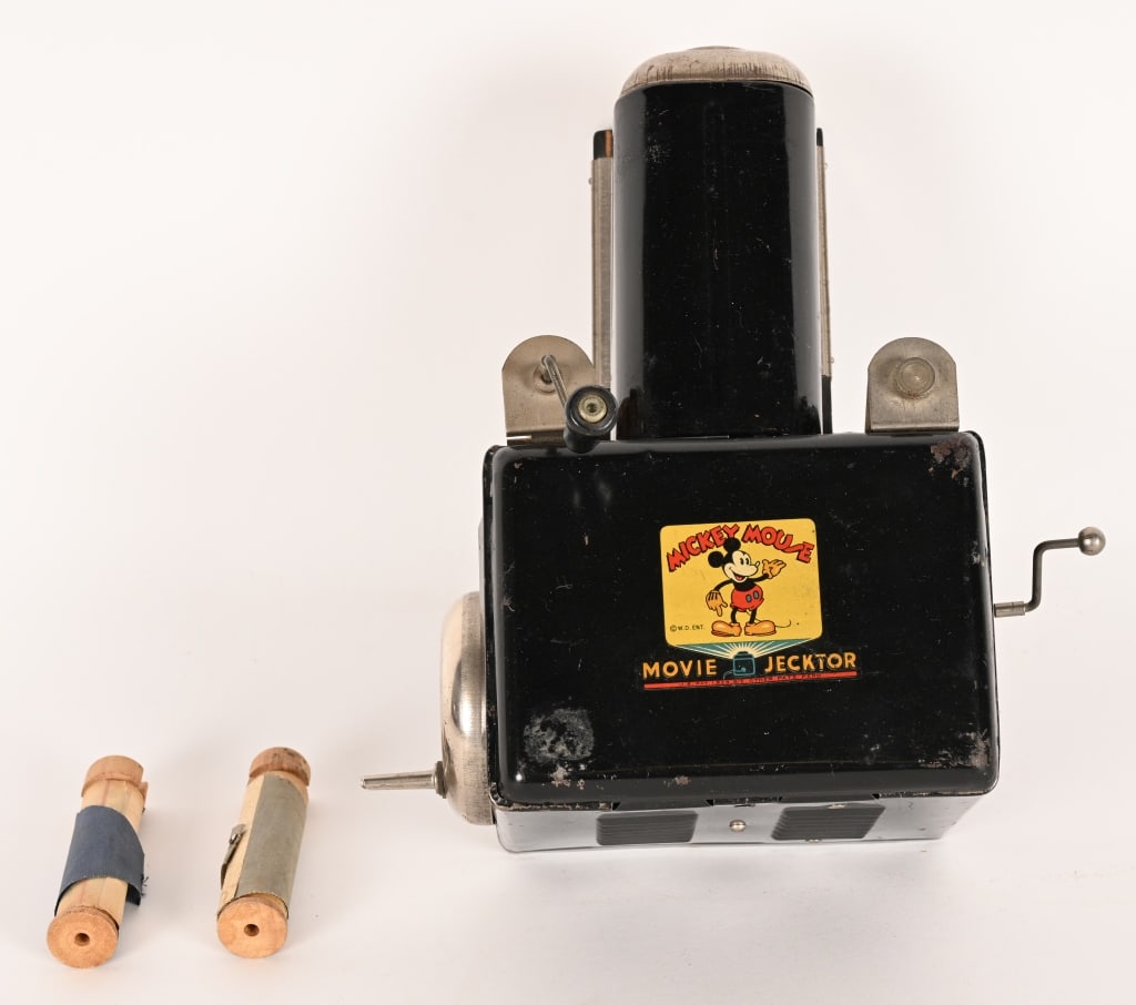MICKEY MOUSE MOVIE JECKTOR: Very early Mickey Mouse Toy Film Projector. Great graphics of Mickey Mouse. Comes with films. Missing cord. 10"x6" Very Good