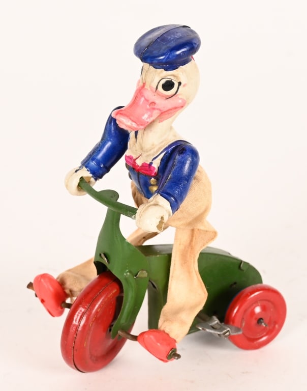 JAPAN WINDUP DONALD DUCK ON TRIKE: Early Japan celluloid and tin windup Donald Duck on Trike. All original and works. Missing bell. 4 1/2" Excellent