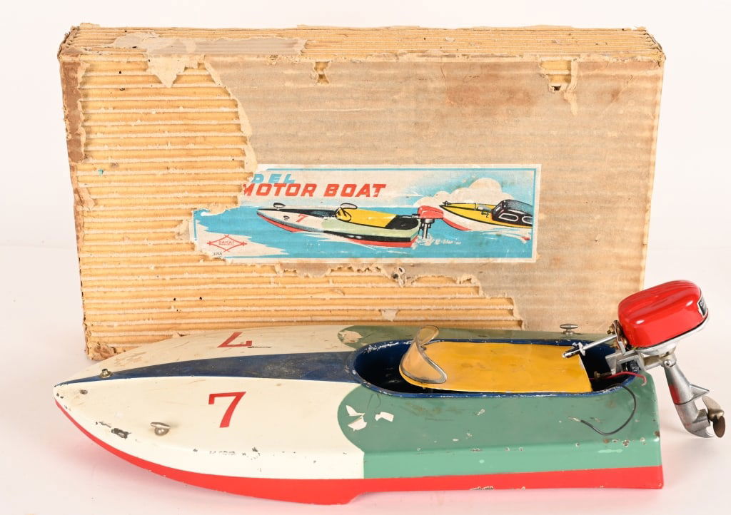 JAPAN TIN BATTERY OP RACING BOAT & MOTOR: Japan tin battery operated Racing Boat with Outboard Motor. All original with some wear. Boxed 16" Very Good