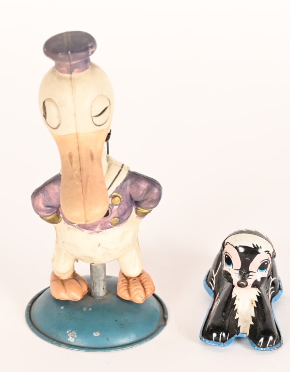 CELLULOID DONALD DUCK & MARX FLOWER: Japan celluloid windup Long Billed Donald Duck Nodder. All original with some wear. Comes with Marx tin friction Flower. Largest 6" Very Good