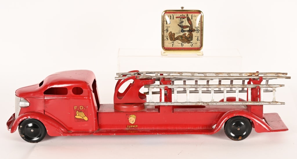 TURNER PRESSED STEEL FIRE LADDER TRUCK: Turner Fire Ladder Truck. All original with nice paint and decals. Comes with ladders. Has new grill 26" Excellent Lot come with Bugs Bunny Alarm Clock that is not working.