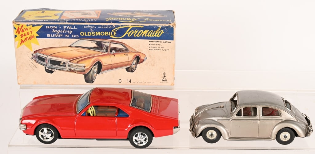 2- JAPAN TIN CARS: Includes battery operated Oldsmobile Tornado with Box and Friction Volkswagon. Largest 10 1/2" Excellent