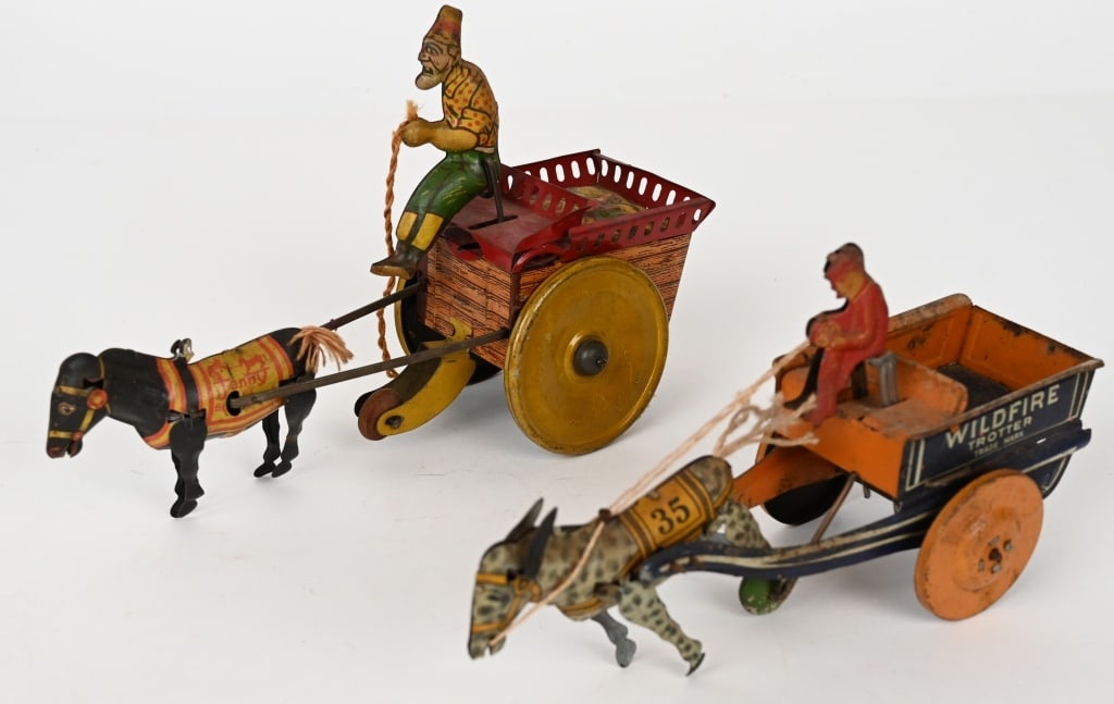2- STRAUSS TIN WINDUP HORSE DRAWN WAGONS: Lot includes: 1. 9" Jenny the Balky Mule, working, missing ears and hat brim, 2. 8" Wildfire Cart, working, complete. Very Good