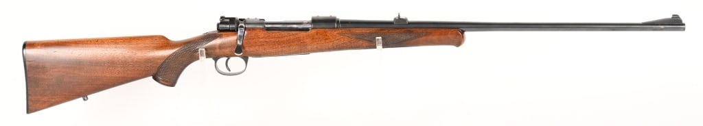 MAUSER 98 SPORTER BOLT ACTION RIFLE 8X57 JS: SERIAL NUMBER: 6796 BARREL: 23 1/2" CALIBER: 8X57 JS MANUFACTURED: 1930 - 1940 Metal is blue finish steel with ramped front and square notch rear sights. Stock is checkered walnut black plastic butt p