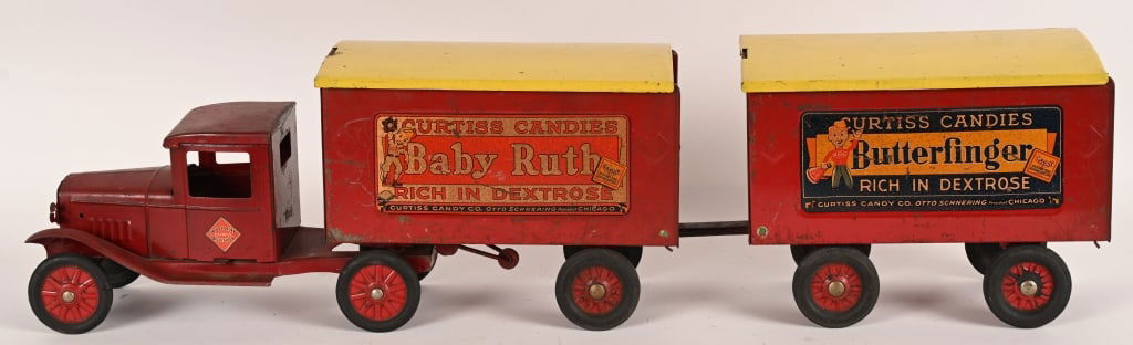BUDDY L TRUCK & CURTISS CANDY TRAILERS: Buddy L pressed steel Truck with Baby Ruth and Butterfinger Trailers. Has electric headlights. Original with decent paint and headlights. Trailer roofs repainted. 40" Excellent