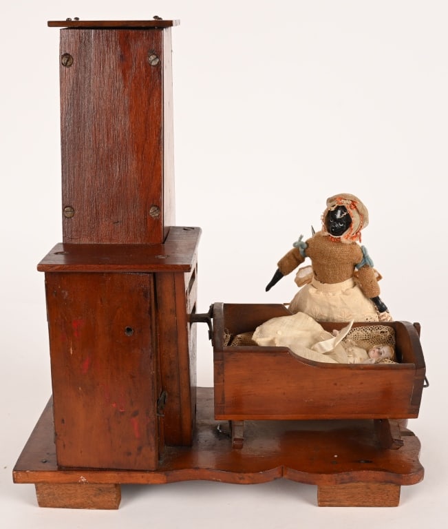 1870s AMERICAN CLOCKWORK BLACK MAMMY w/ CRADLE: Very early toy with china doll black mammy with porcelain baby in cradle. Toy is wooden with early weighted clock work style mech. Toy is all original and in amazing condition. Marked I.G. Williams Ha