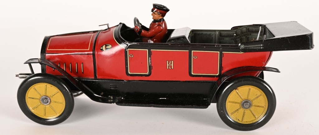 HESS TIN WINDUP HESSMOBILE OPEN TOURING CAR: Hess #1023 tin windup Hessmobil Open Touring Car. All original and complete with driver. Nice condition. Front windup works.11" Excellent