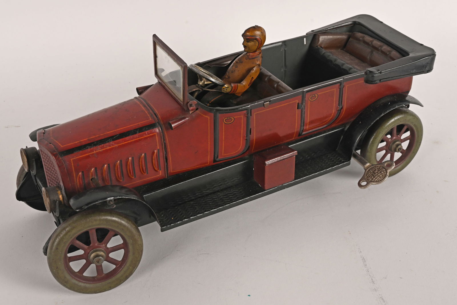 DISTLER TIN WINDUP TWO SEAT OPEN TOURING CAR: Distler tin windup Two seat Open Touring Car. Wonderful original condition. Has Driver and Glass Windshield. A very impressive looking toy car. Windup works. 12" Excellent