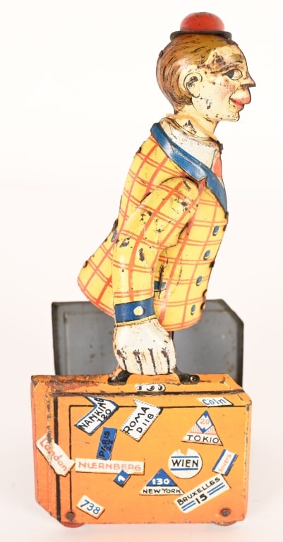 DISTLER TIN WINDUP PORTER WITH LUGGAGE: German tin windup Porter with Luggage. All original and complete. Windup works. Has some edge wear 7 1/2" Very Good-Excellent