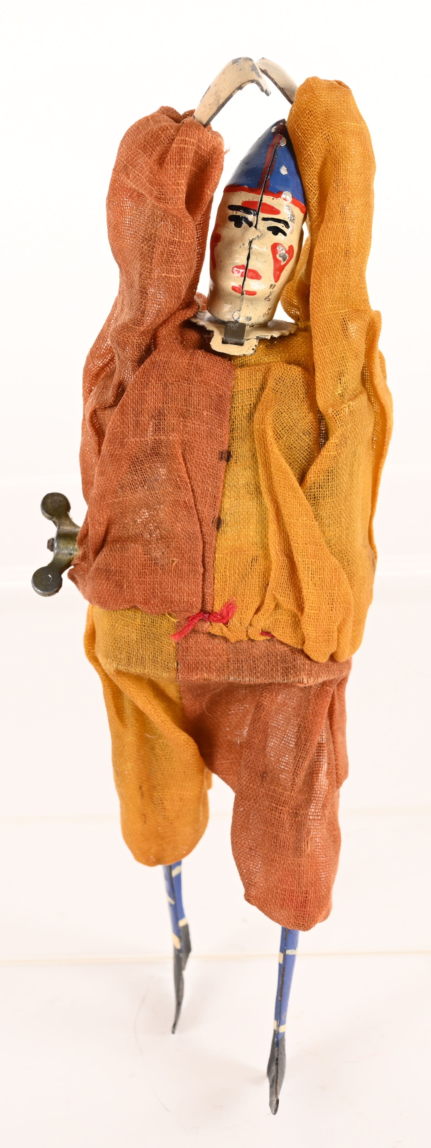 GERMAN HAND PAINTED TIN WINDUP CLOWN ROPE WALKER: German hand painted tin windup Clown Rope walker. Scarce toy with hand painted features and cloth dressed. When operated his hands move in a back and forth motion while he kicks his legs. Works well.